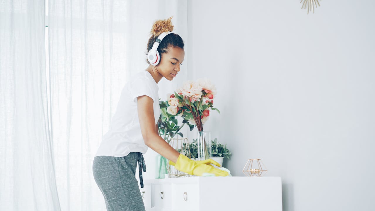 about-us woman-cleaning-with-headphones-in-bright-room-36729581